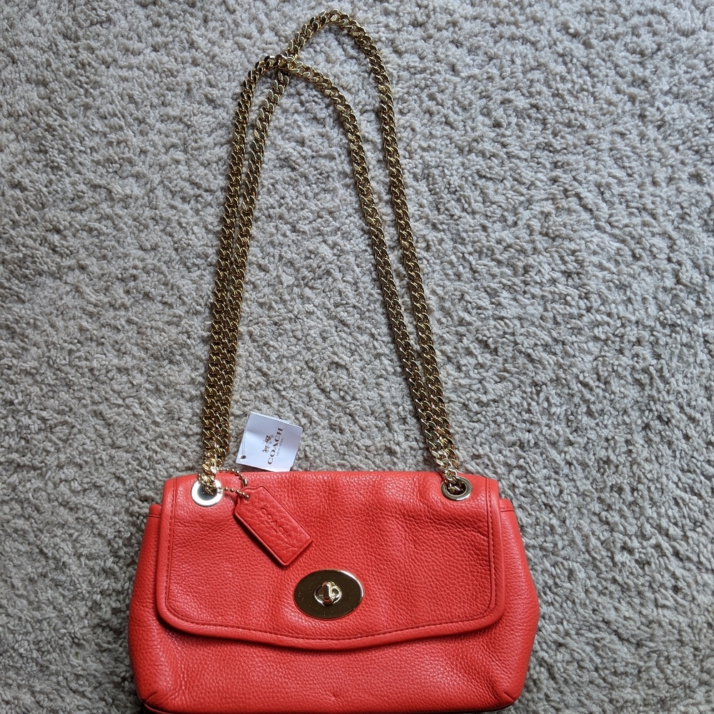 COACH red pouch with gold hardware